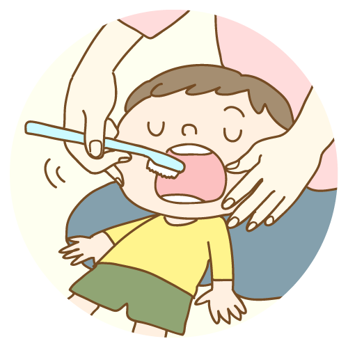 仕上げみがきをしてもらう子ども